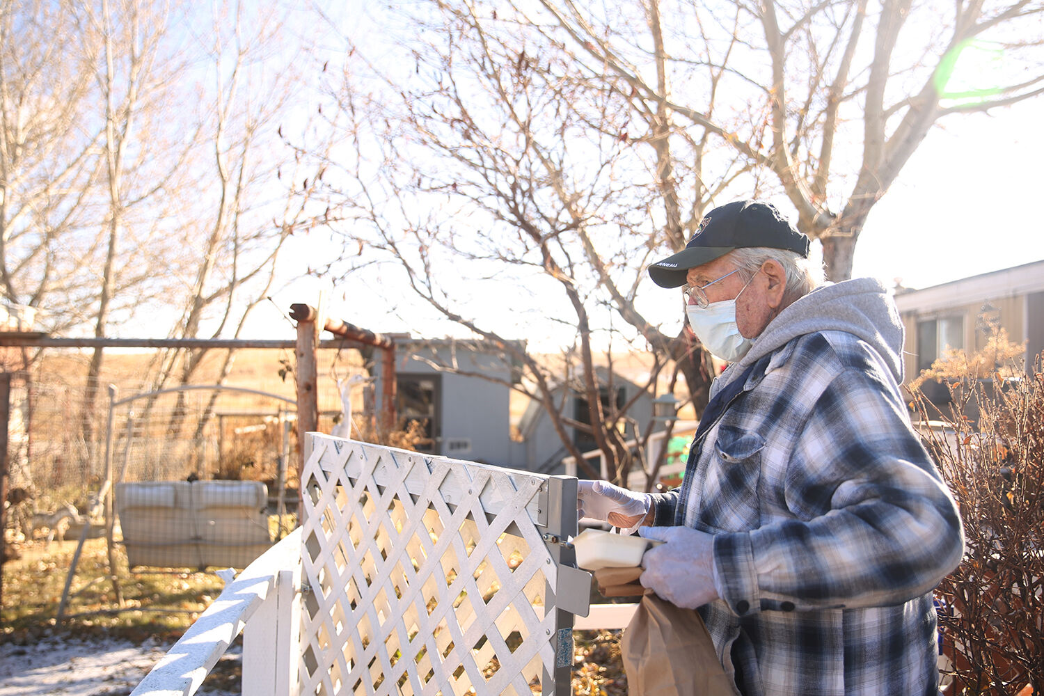Leo Sampson opens the gate of a house to drop off a meal